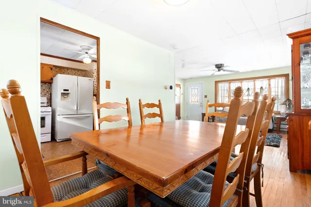 a dining room with furniture and wooden floor