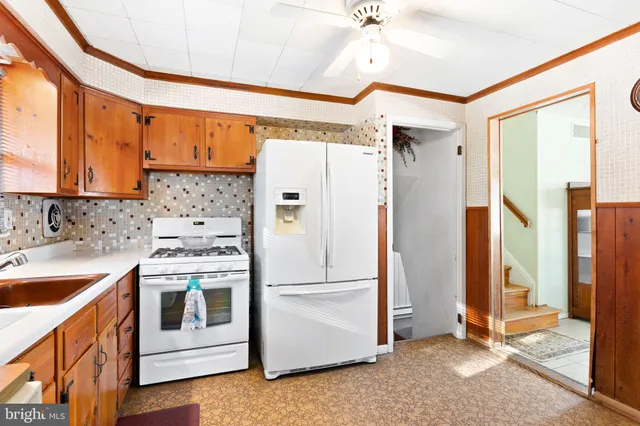 a kitchen with stainless steel appliances a refrigerator sink and cabinets