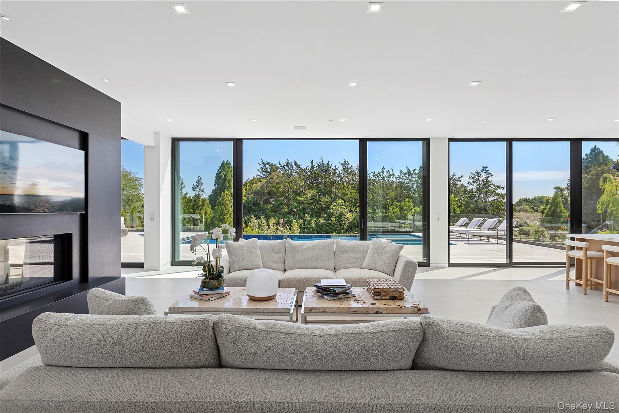 99 Pointe Mecox Lane Bridgehampton, NY 11976 - Photo 13 of 50 Living area with floor to ceiling windows and recessed lighting