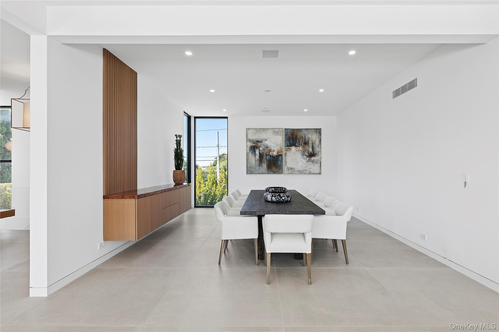 99 Pointe Mecox Lane Bridgehampton, NY 11976 - Photo 16 of 50 Dining room featuring a wall of windows and recessed lighting