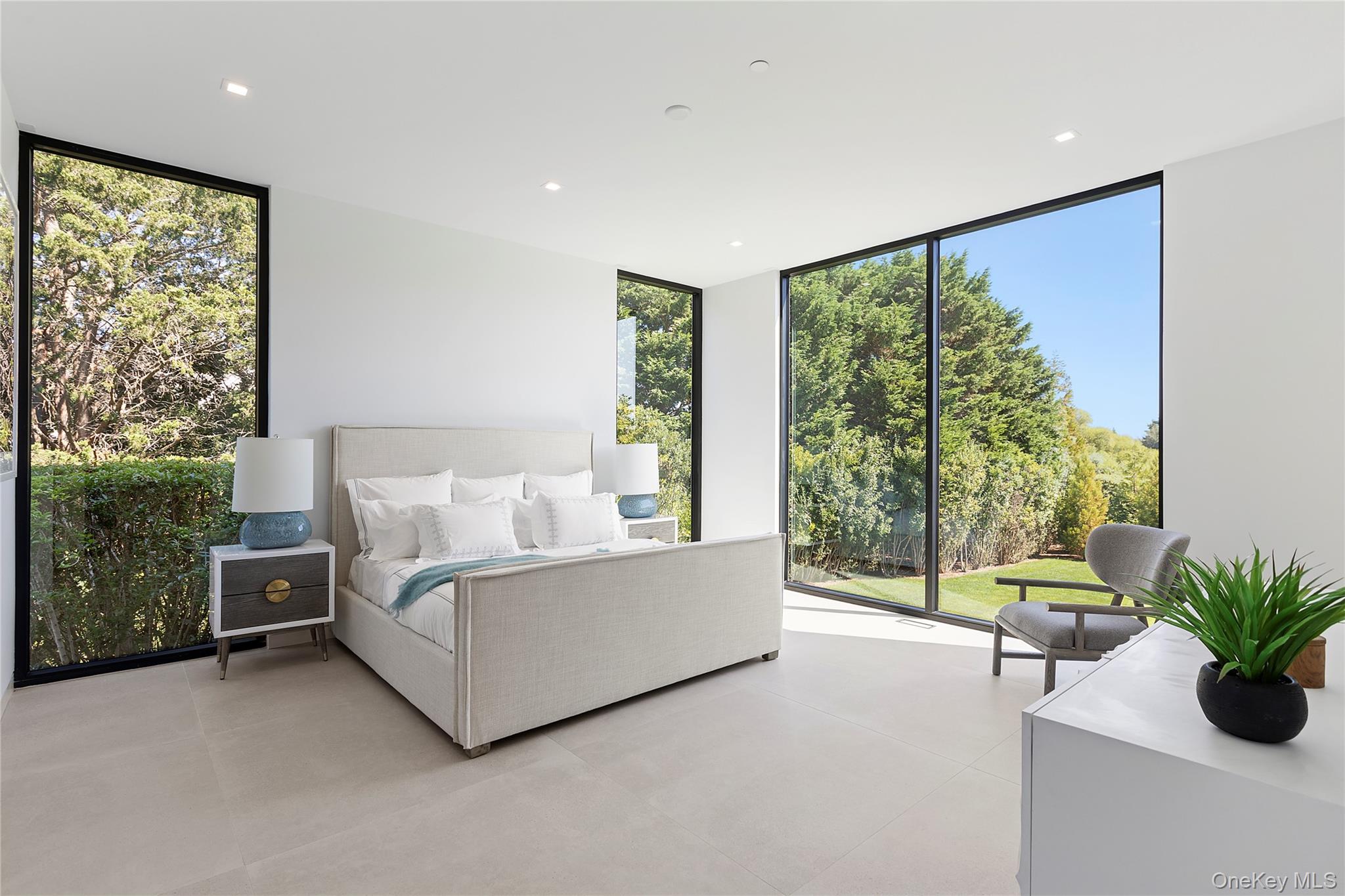 99 Pointe Mecox Lane Bridgehampton, NY 11976 - Photo 25 of 50 Bedroom with a wall of windows, recessed lighting, multiple windows, and light tile patterned floors