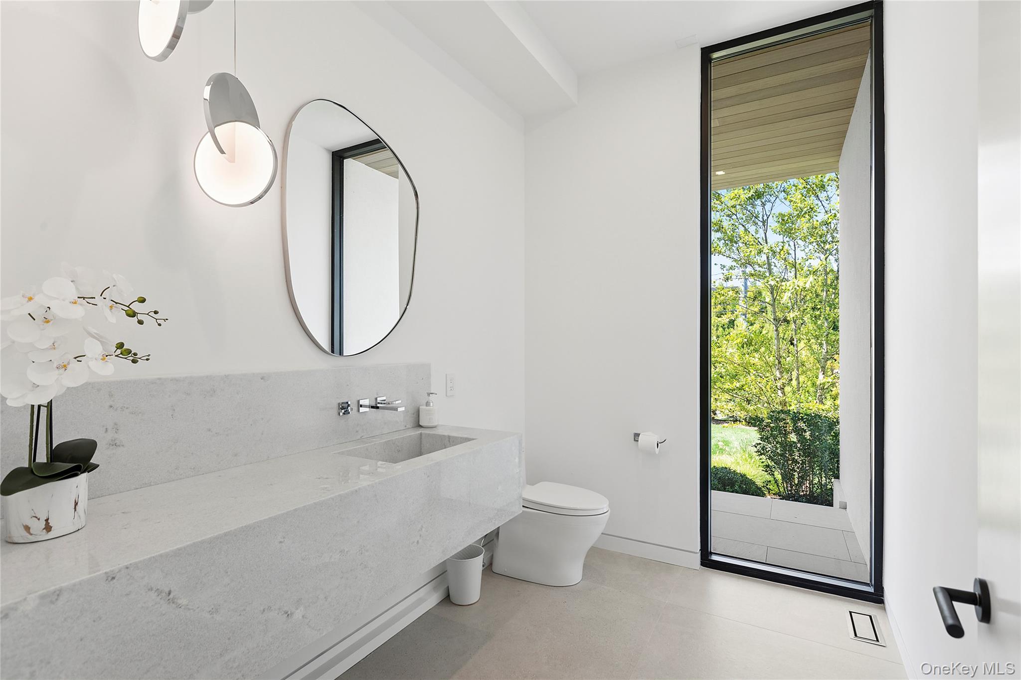 99 Pointe Mecox Lane Bridgehampton, NY 11976 - Photo 30 of 50 Half bathroom featuring toilet and a sink