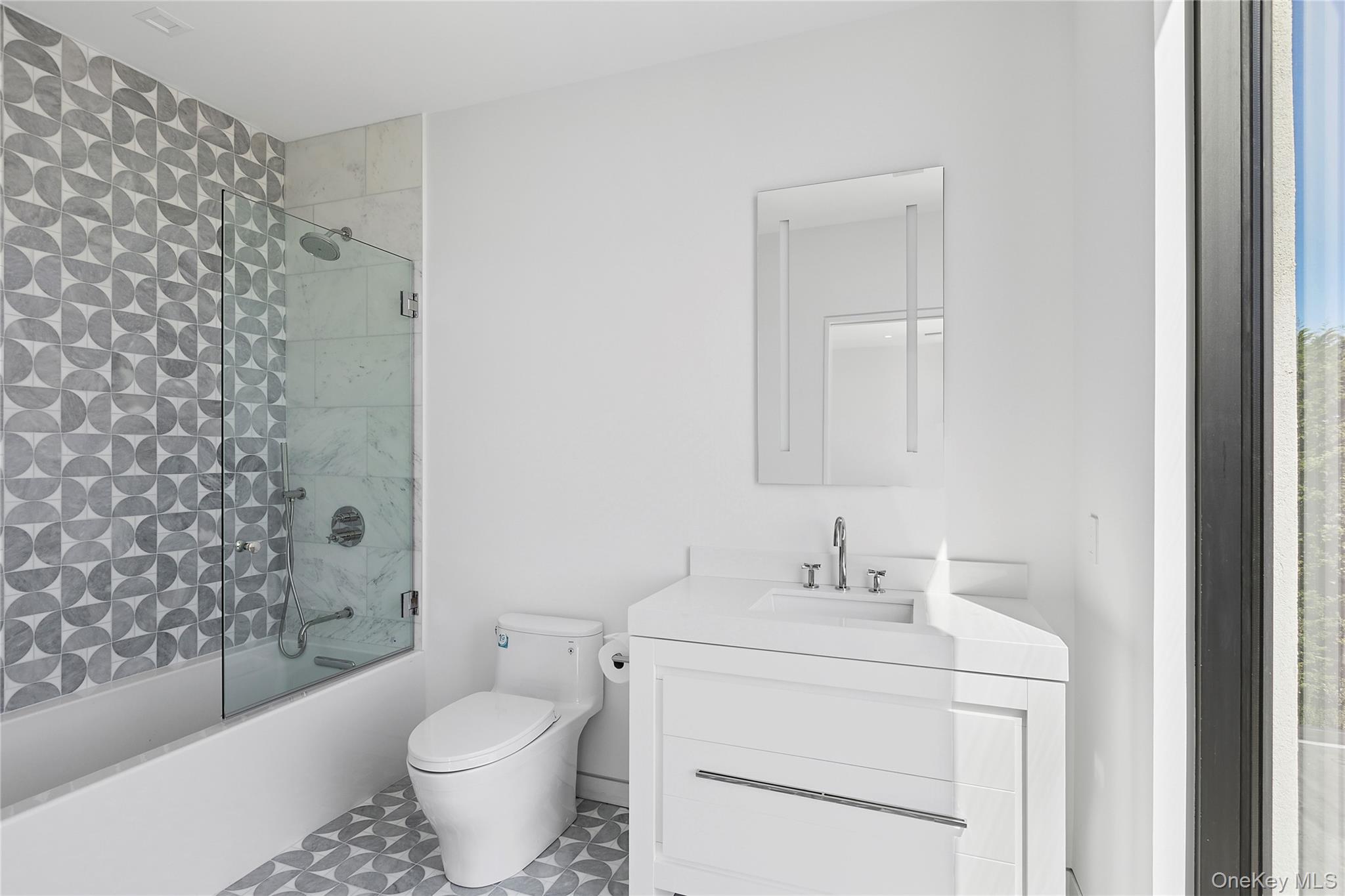 99 Pointe Mecox Lane Bridgehampton, NY 11976 - Photo 34 of 50 Full bath with enclosed tub / shower combo, vanity, and tile patterned flooring