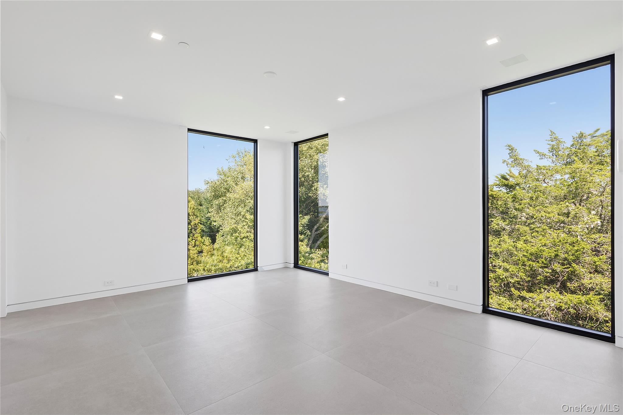 99 Pointe Mecox Lane Bridgehampton, NY 11976 - Photo 35 of 50 Spare room featuring floor to ceiling windows and recessed lighting