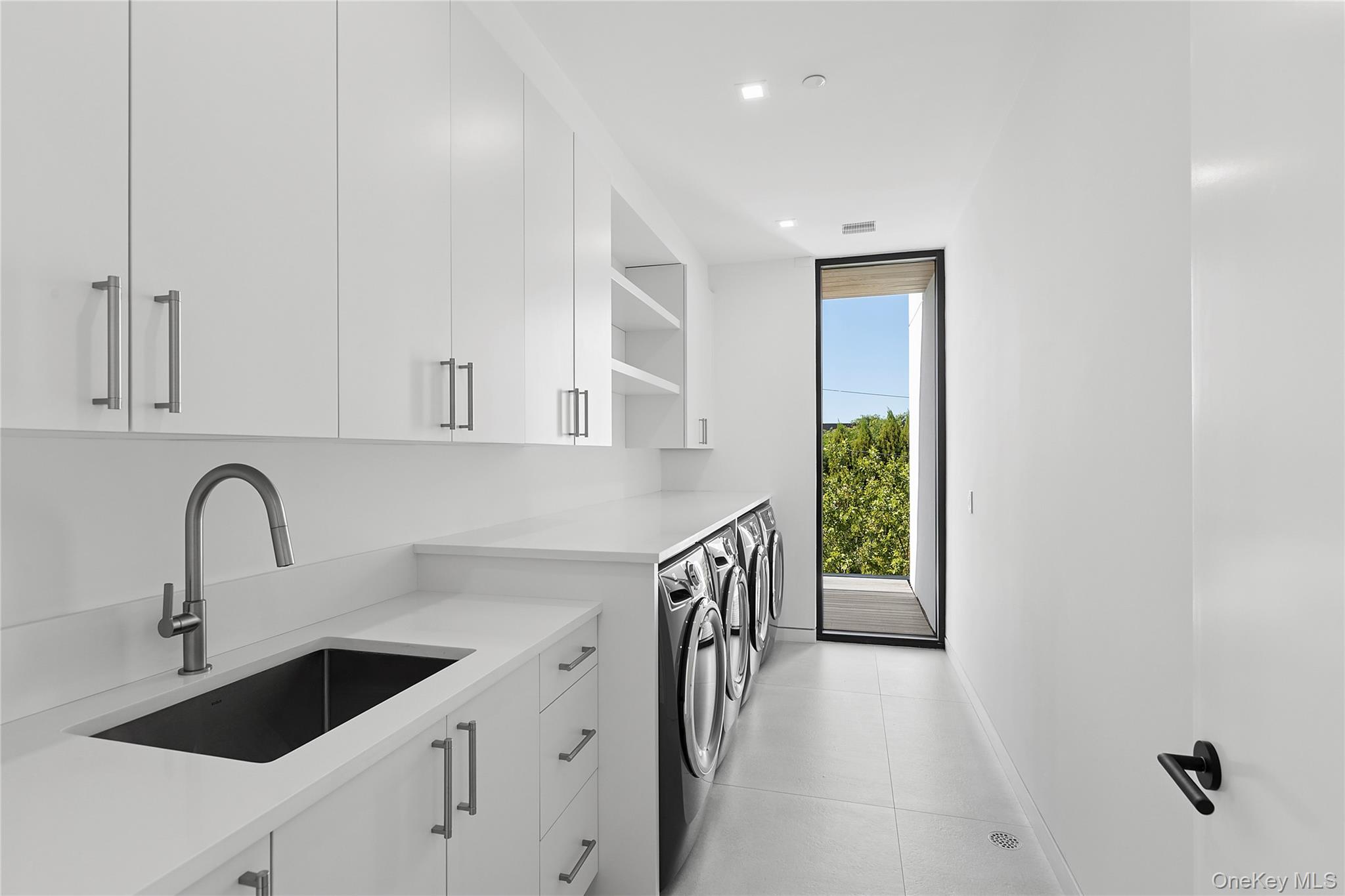 99 Pointe Mecox Lane Bridgehampton, NY 11976 - Photo 47 of 50 Laundry room featuring independent washer and dryer, cabinet space, and recessed lighting