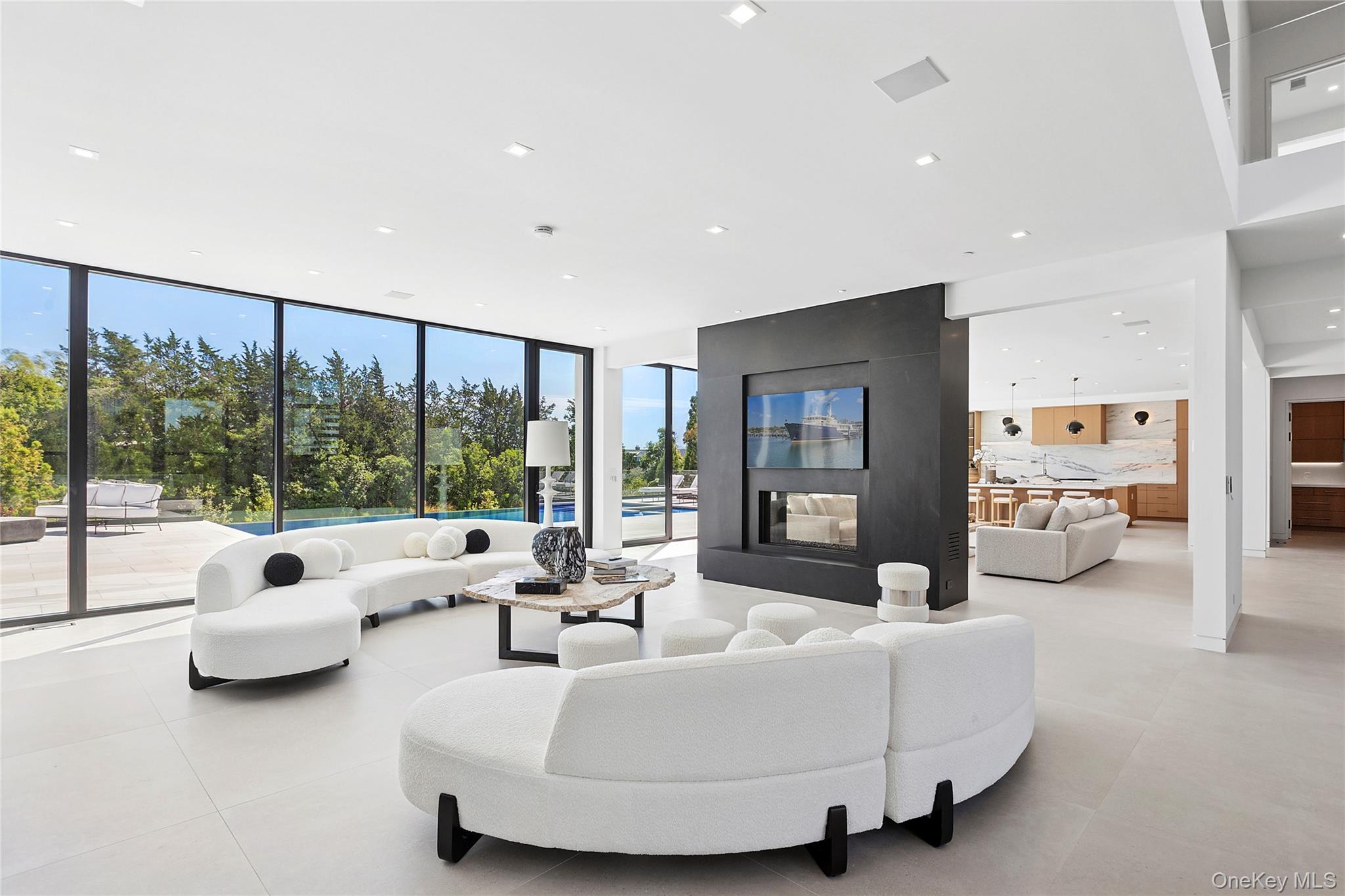 99 Pointe Mecox Lane Bridgehampton, NY 11976 - Photo 10 of 50 Living area featuring floor to ceiling windows, recessed lighting, and light tile patterned floors
