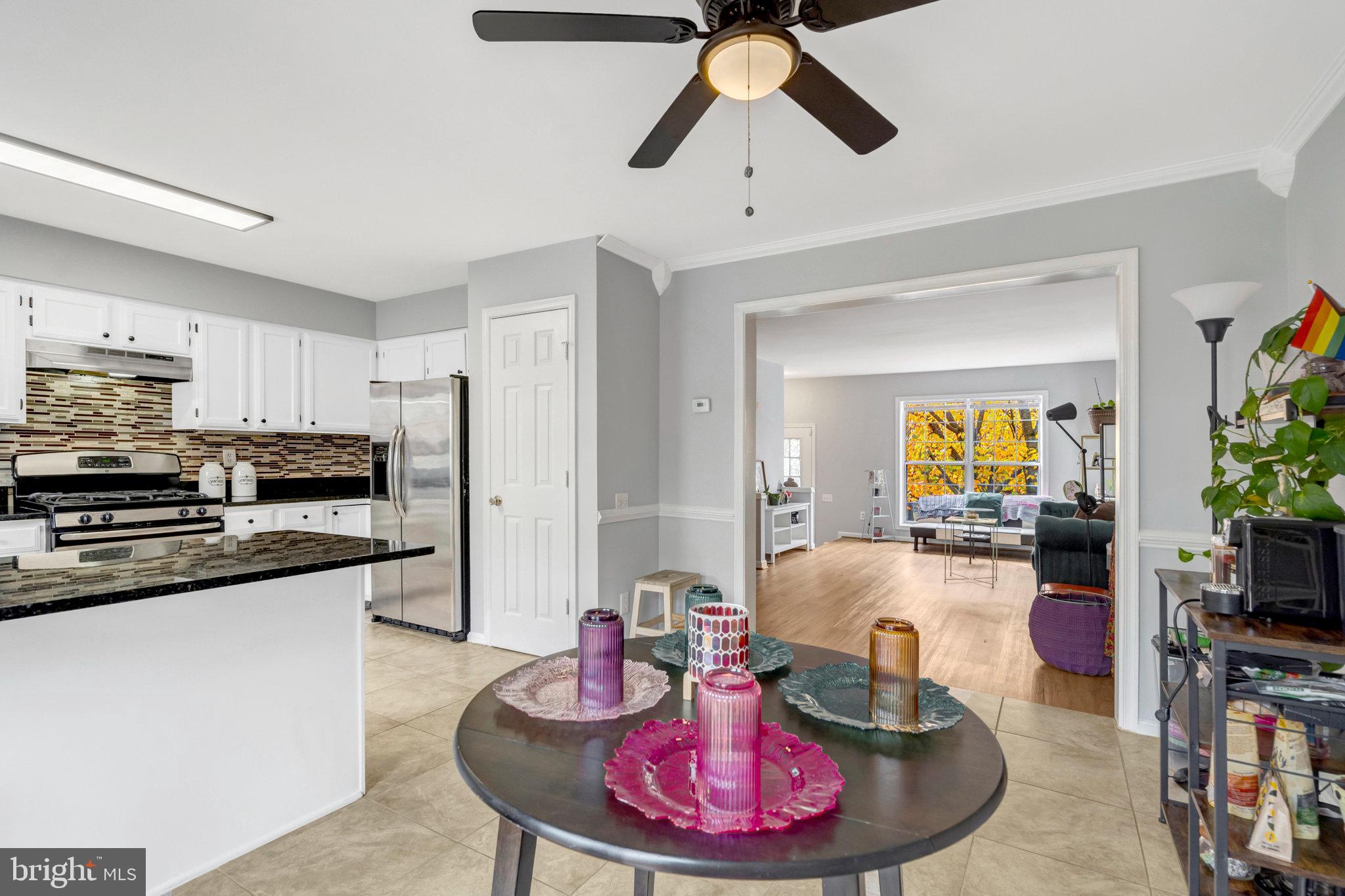 7905 Rebel Walk Drive Manassas, VA 20109 - Photo 12 of 51 a living room with stainless steel appliances furniture a rug and a view