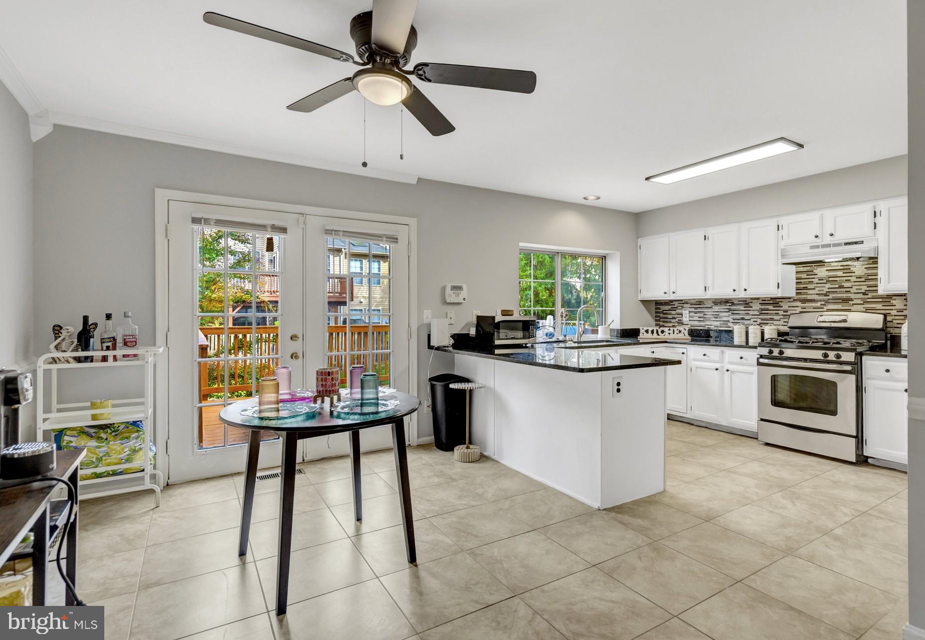 7905 Rebel Walk Drive Manassas, VA 20109 - Photo 13 of 51 a kitchen with a stove cabinets and chairs