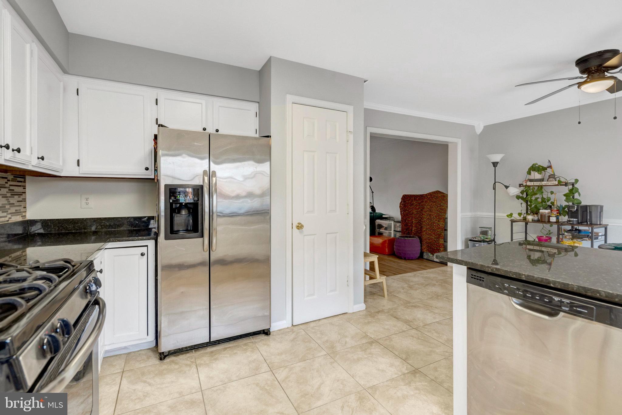 7905 Rebel Walk Drive Manassas, VA 20109 - Photo 16 of 51 a kitchen with stainless steel appliances granite countertop a refrigerator and a stove