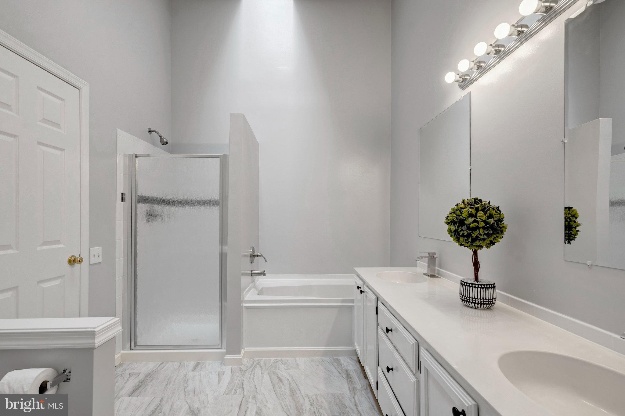 7905 Rebel Walk Drive Manassas, VA 20109 - Photo 29 of 51 a bathroom with a double vanity sink a toilet and shower