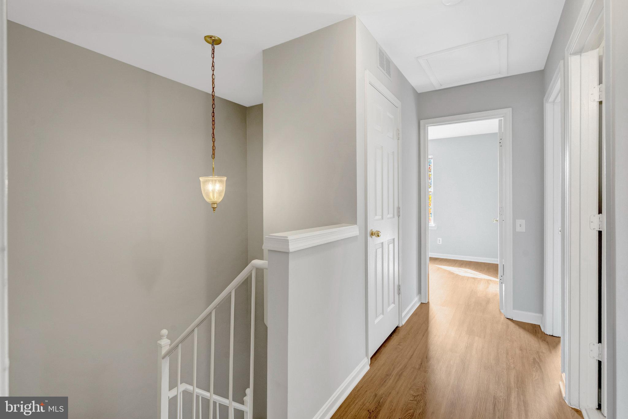 7905 Rebel Walk Drive Manassas, VA 20109 - Photo 31 of 51 a view of a hallway with wooden floor