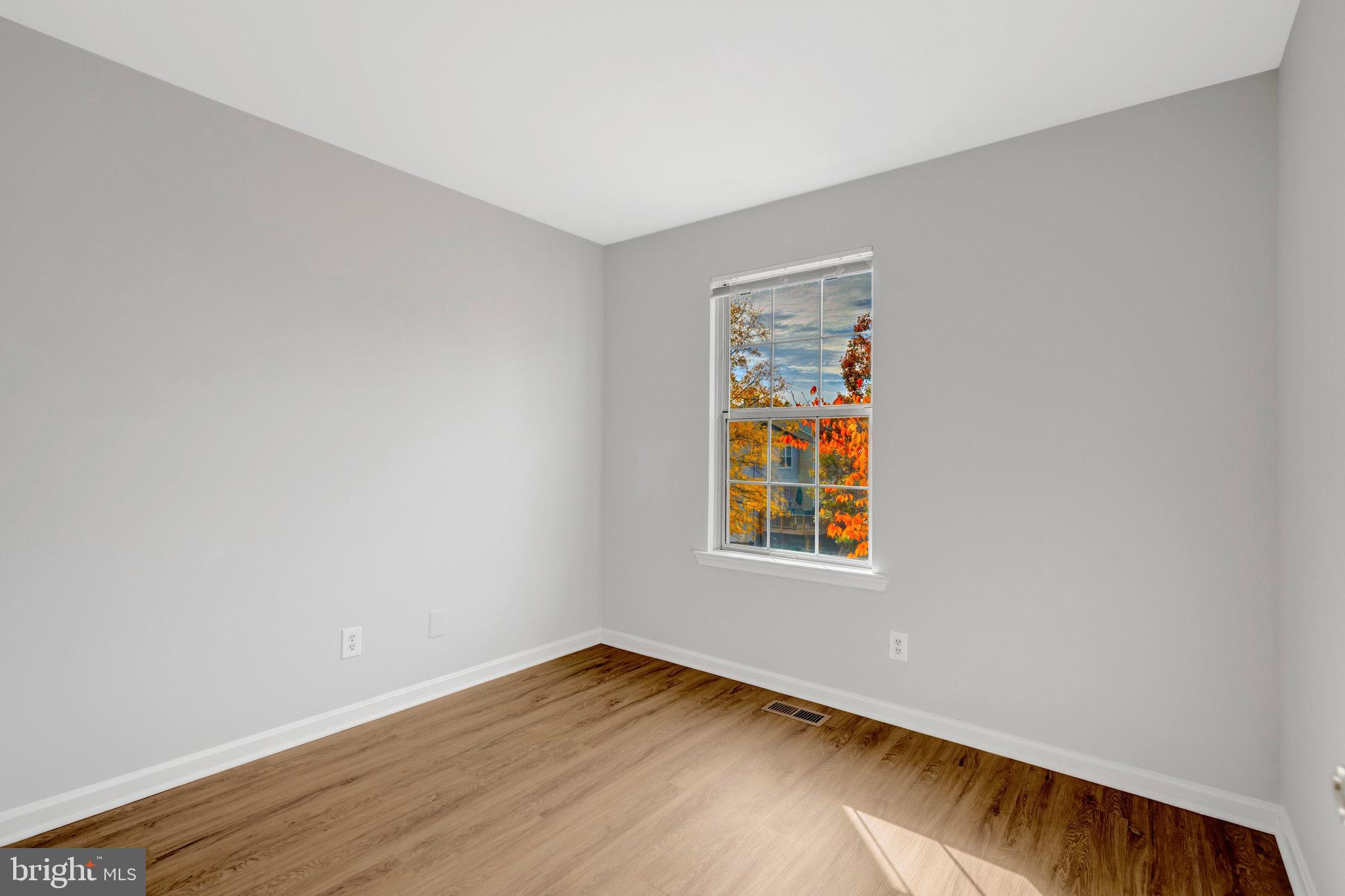 7905 Rebel Walk Drive Manassas, VA 20109 - Photo 32 of 51 a view of an empty room with wooden floor and a window
