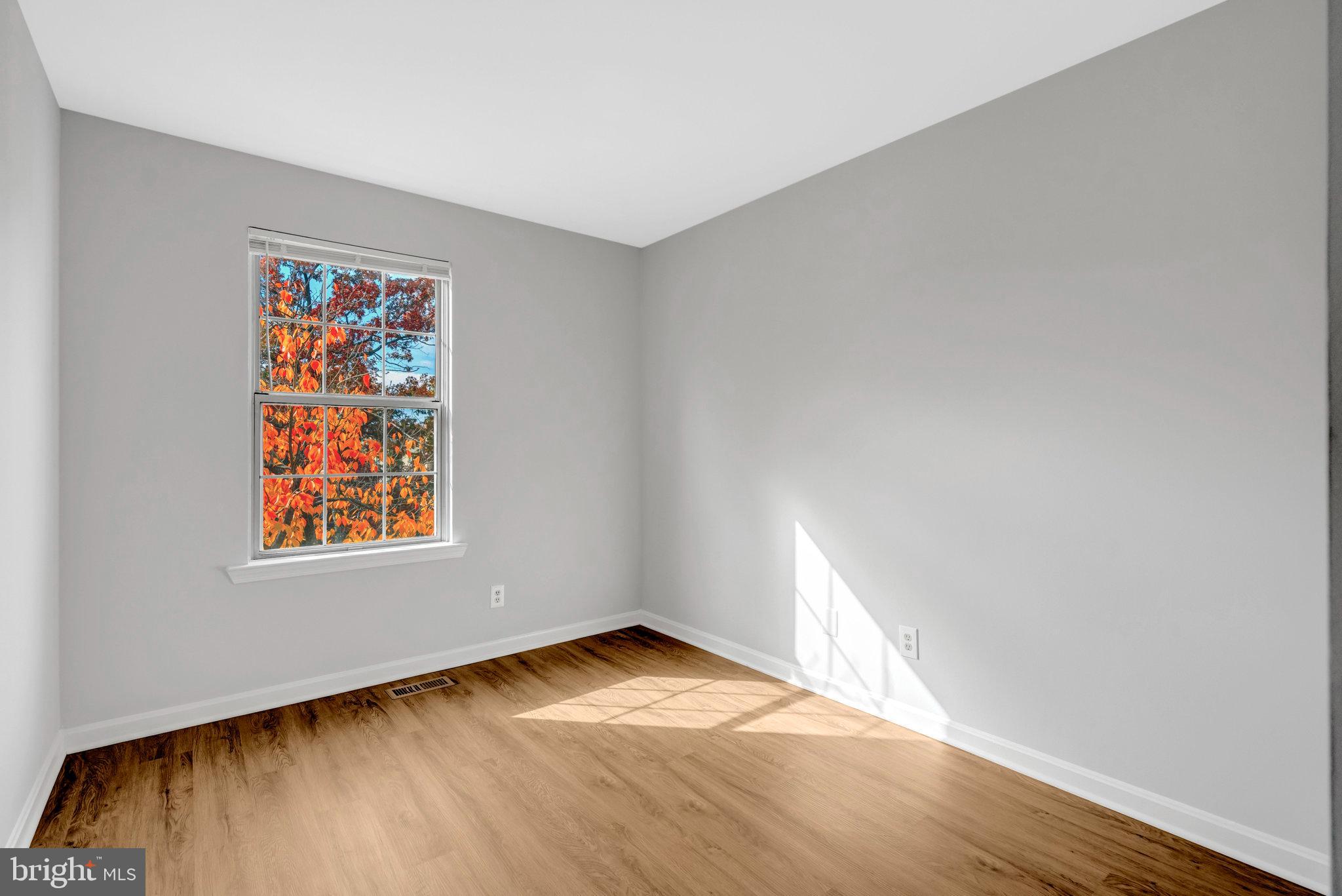 7905 Rebel Walk Drive Manassas, VA 20109 - Photo 36 of 51 an empty room with wooden floor and windows