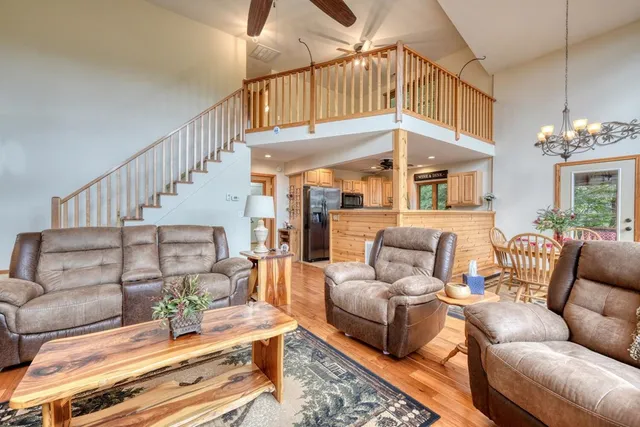 a bedroom with a large bed and a chandelier