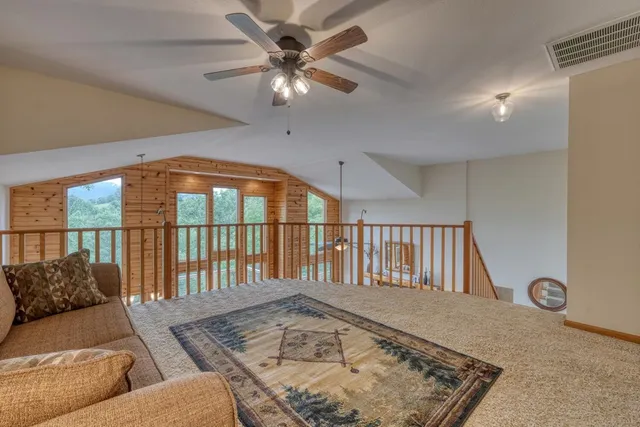 a spacious bedroom with a bed and a chandelier