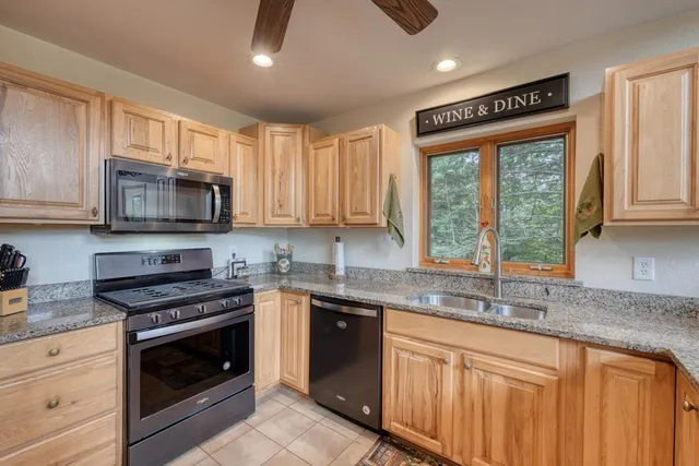 a living room with furniture a flat screen tv and a floor to ceiling window