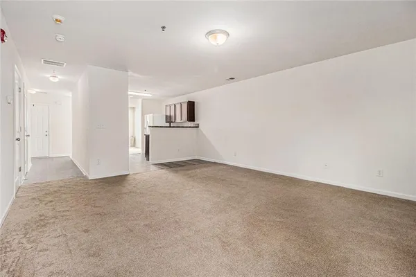 a view of a kitchen with a sink and a refrigerator