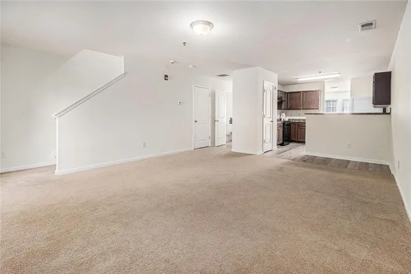 a view of a kitchen with a sink and a refrigerator