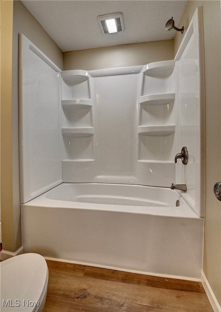 4624 Ridge Avenue Southeast Canton, OH 44707 - Photo 18 of 48 Bathroom with light wood-style floors, shower / bathtub combination, and a textured ceiling