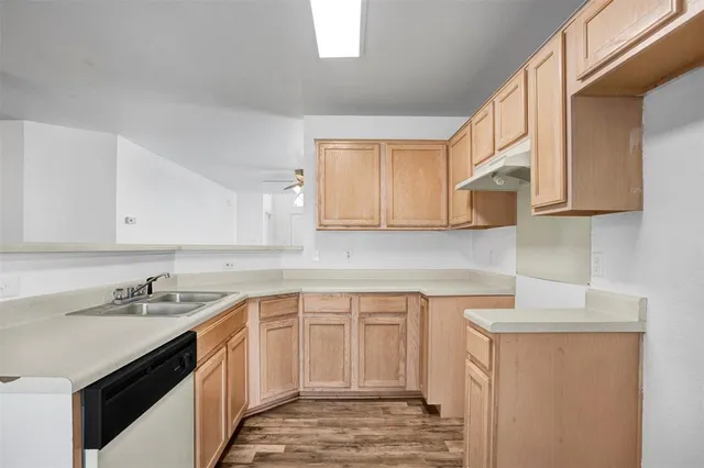 a kitchen with a sink and a refrigerator