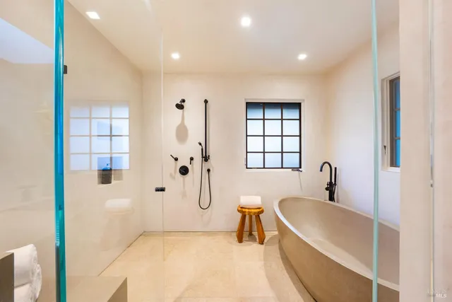 a living room with fireplace furniture and a large window