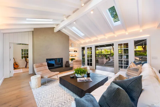 a living room with stainless steel appliances kitchen island granite countertop furniture and a view of kitchen
