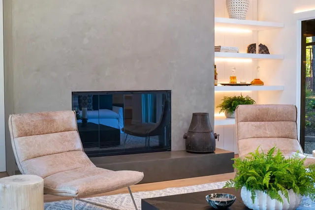 a living room with couches chairs and kitchen view