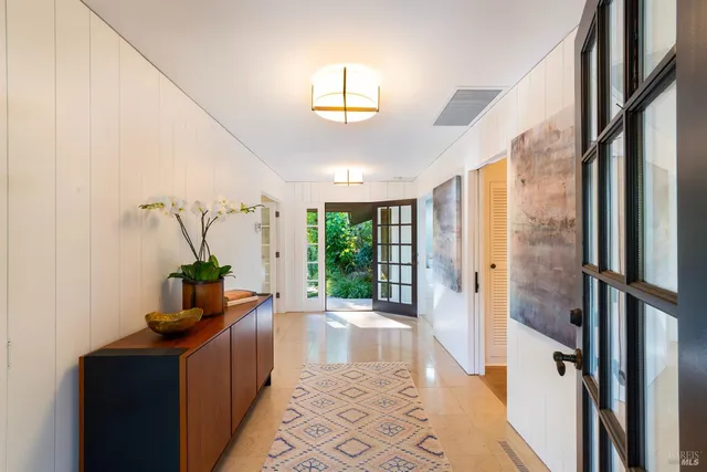 a view of a backyard with plants and a patio