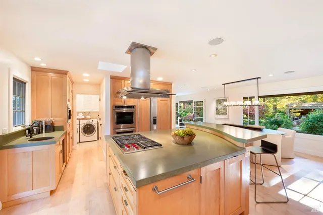 a kitchen with stainless steel appliances granite countertop a sink stove and refrigerator
