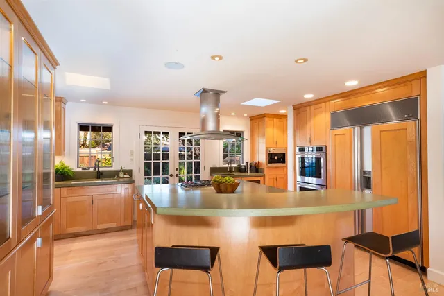 a view of a kitchen with a sink a washer and dryer next to a window