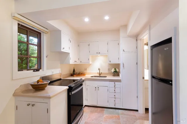 a bedroom with furniture and a large window