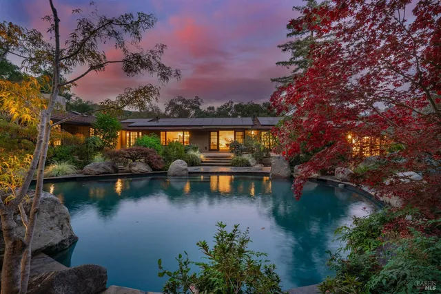 a view of a lake with a garden and trees