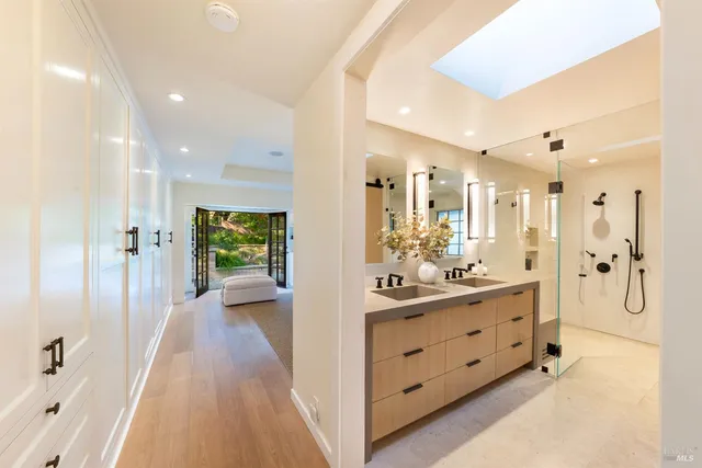 a bathroom with a tub sink and mirror