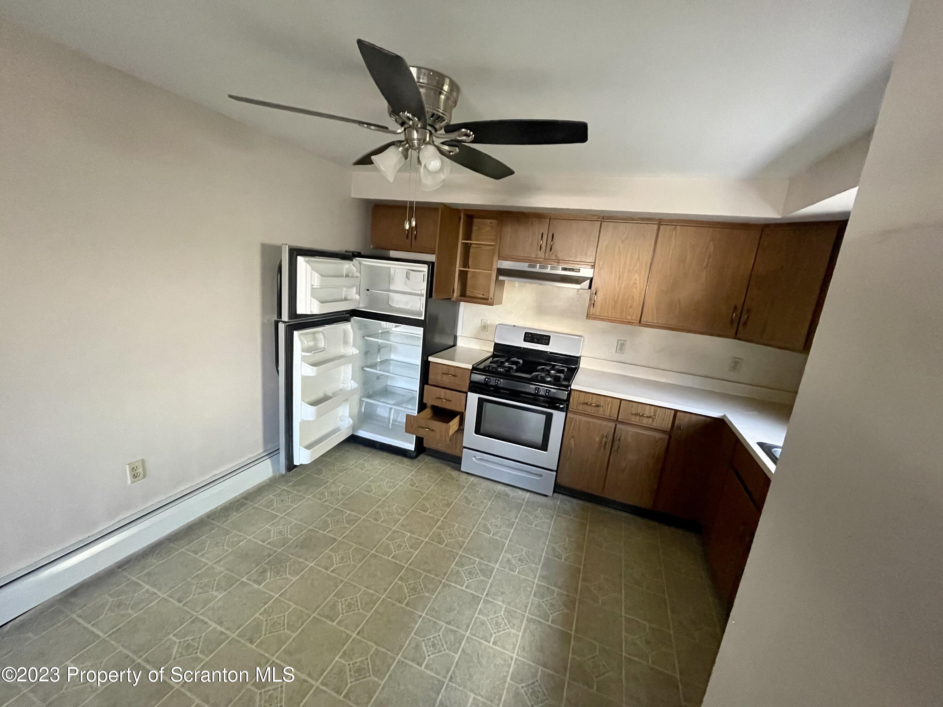 113 Frank Street, Unit 4 Dunmore, PA 18512 - Photo 2 of 10 a view of kitchen and empty room with wooden floor