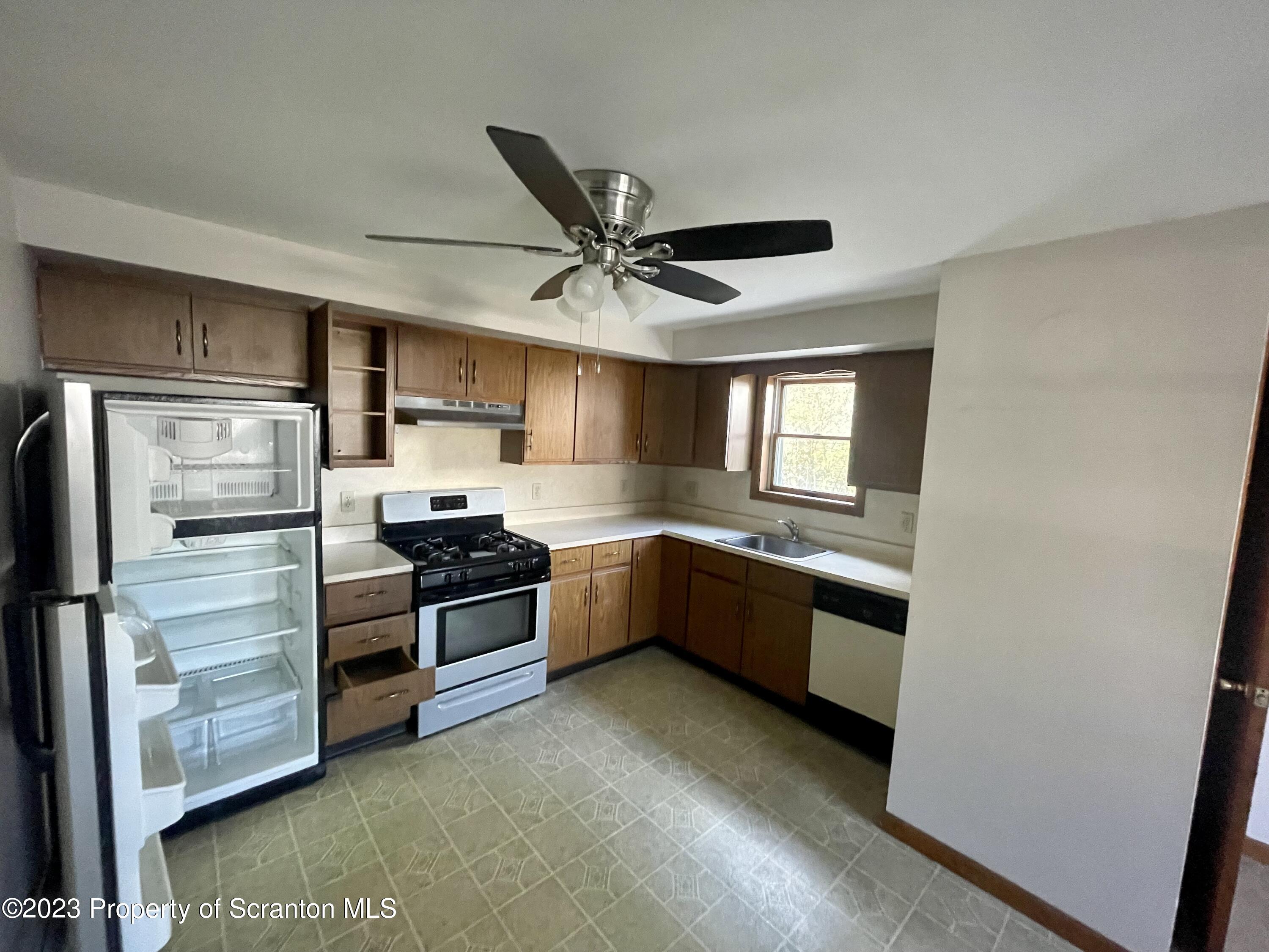 113 Frank Street, Unit 4 Dunmore, PA 18512 - Photo 3 of 10 a kitchen with granite countertop a refrigerator and a sink