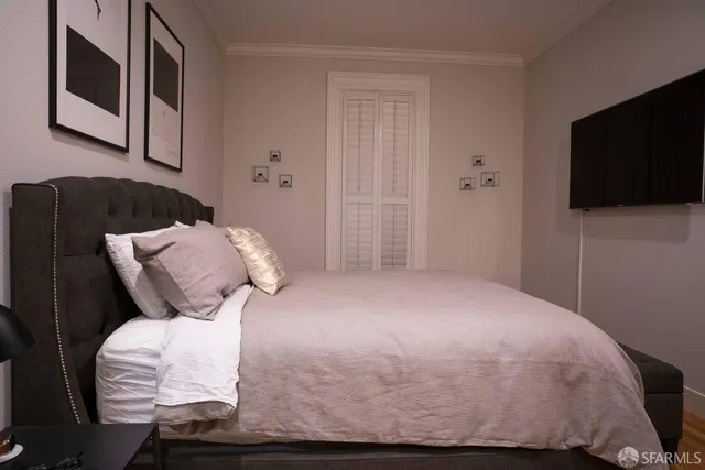 a bedroom with a bed and a flat screen tv