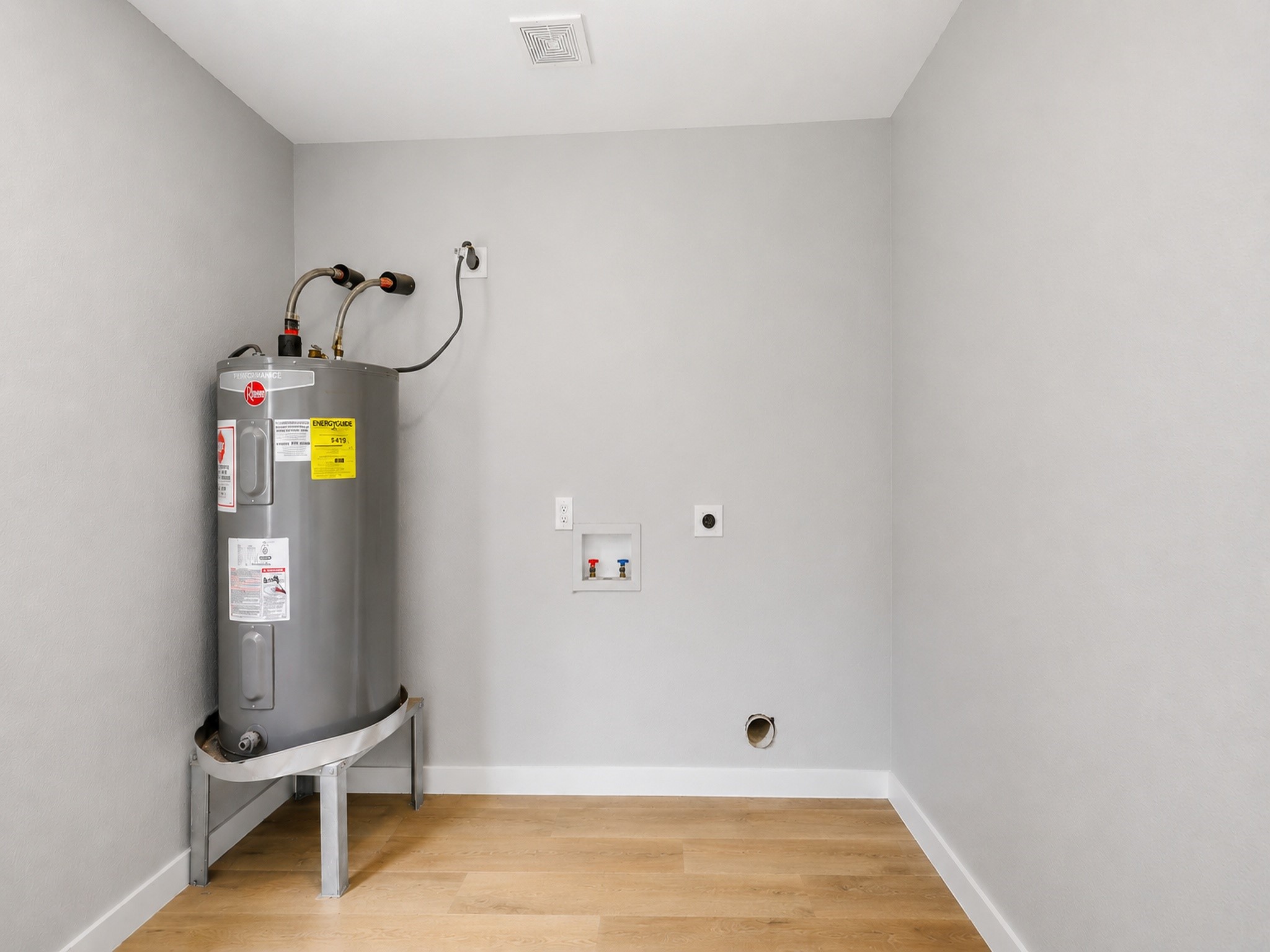 10430 Wiggins Street Houston, TX 77029 - Photo 26 of 27 This utility room features a water heater, shelving, and a door leading outside. The space is practical for storage and maintenance needs.