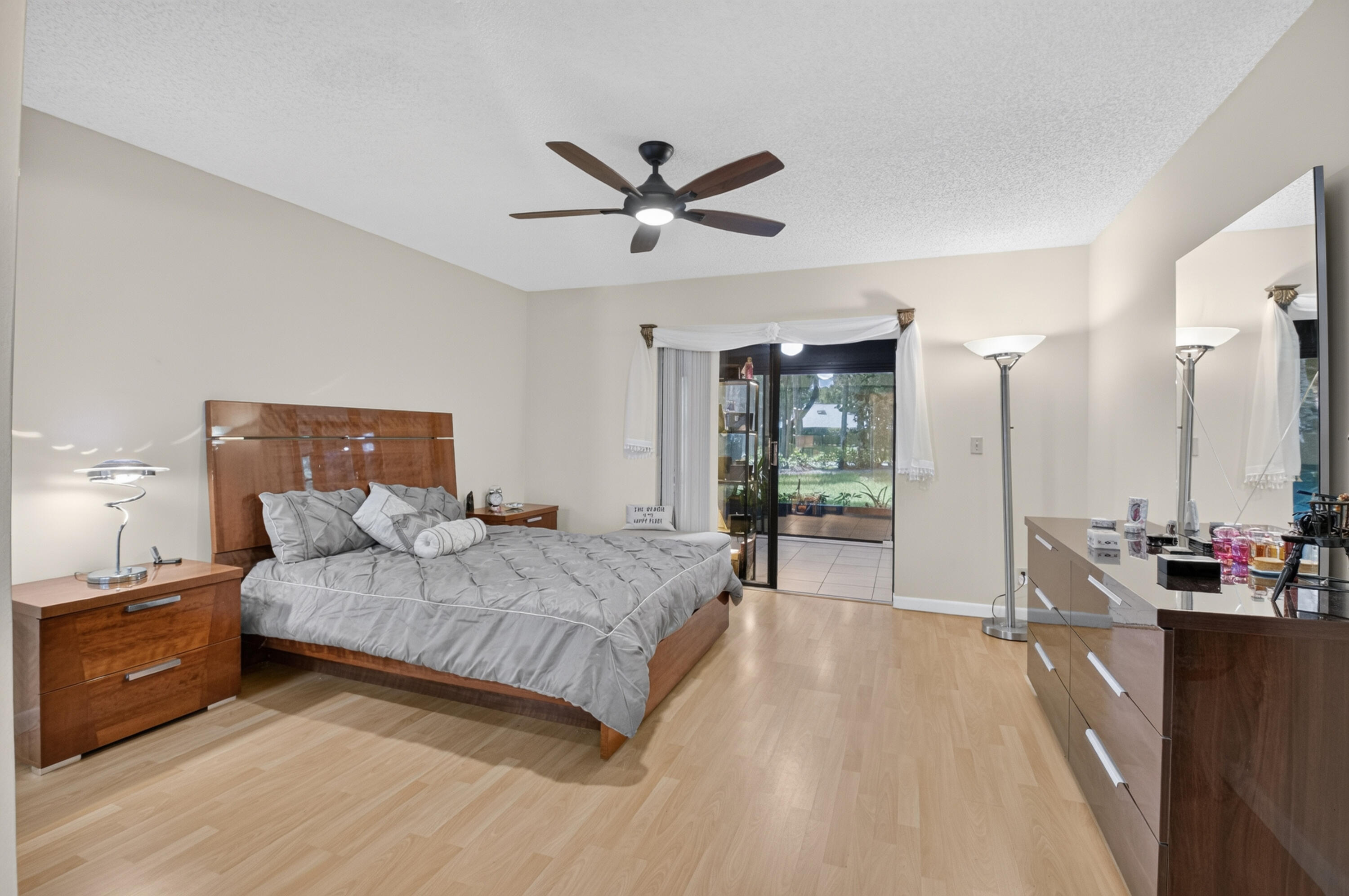 8246 Springview Terrace Boca Raton, FL 33496 - Photo 20 of 53 a spacious bedroom with a bed and ceiling fan