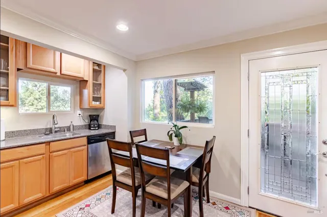 a view of a dining room with furniture and window