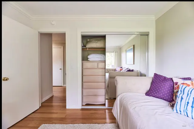 a bedroom with a bed and a mirror