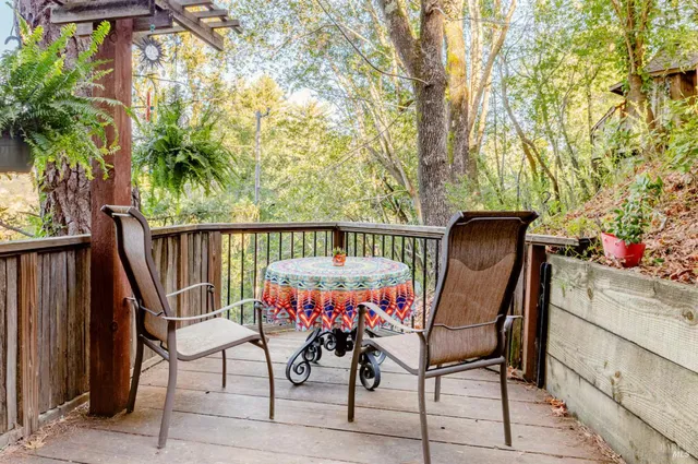 a view of a chairs and table in the balcony