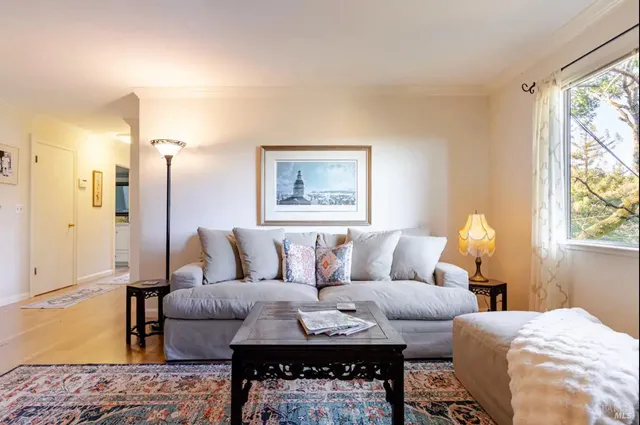 a living room with furniture a lamp and a table