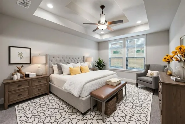 a spacious bedroom with a bed and a chandelier