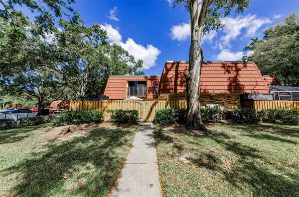 a pathway of a house with a yard