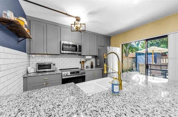 a kitchen with a stove a sink and a microwave