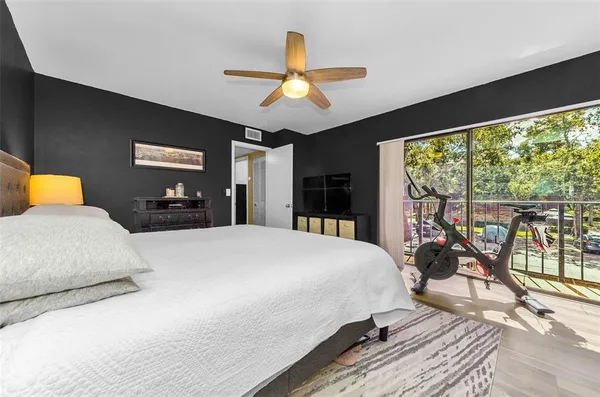 a bedroom with a large bed and a large window