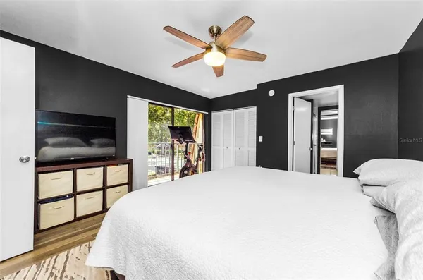 a bedroom with a bed and a large window