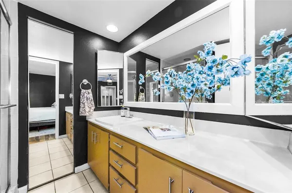 a bathroom with a granite countertop sink and a mirror