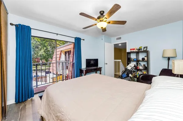 a bedroom with a large bed and a large window