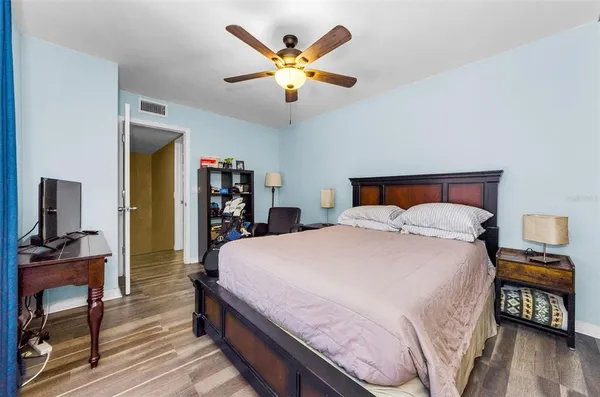 a bedroom with a large bed and a chandelier